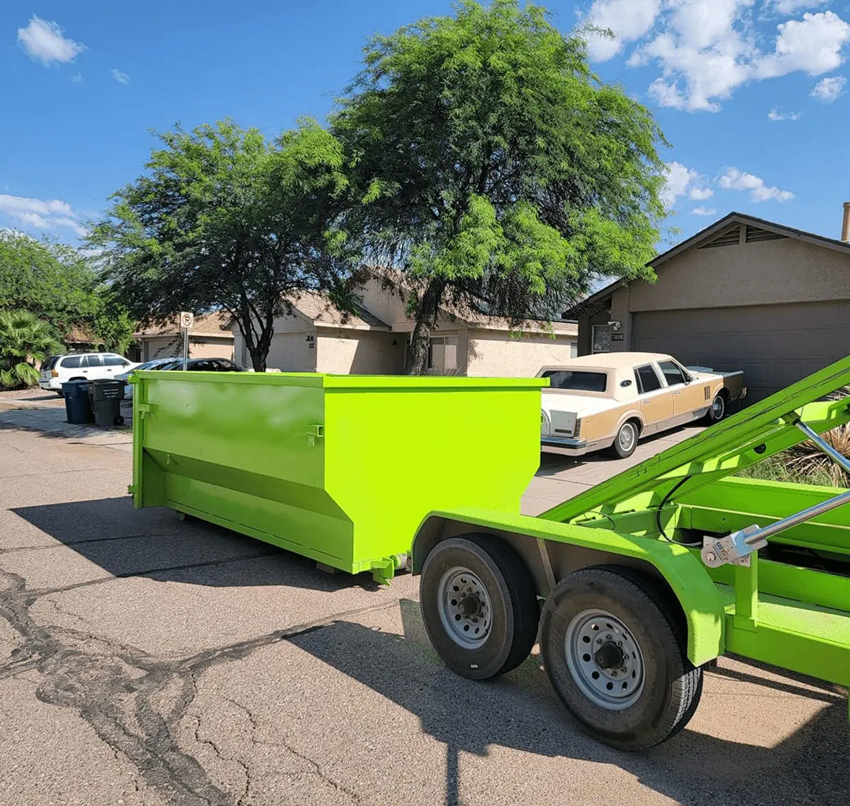 Bright green trailer on suburban street.
